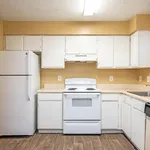 Bright and welcoming kitchen with modern appliances, ample cabinetry, and elegant hardwood floors.