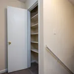 Spacious hallway closet with ample shelving, perfect for organized storage in a modern apartment.