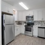 Modern kitchen with sleek stainless steel appliances, chic white cabinetry, and elegant tile backsplash.