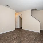 Inviting room with elegant hardwood floors, neutral walls, and a stylish doorway leading to a cozy space perfect for versatile living.