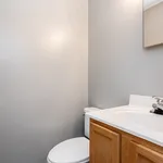 Modern bathroom with sleek design, featuring a wood-accented vanity and elegant fixtures.