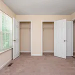 Bright and inviting bedroom with plush carpet and dual closets, offering ample storage space.