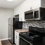 Modern kitchen with sleek stainless steel appliances, elegant tile backsplash, and bright white cabinetry.