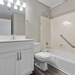 Modern bathroom with elegant fixtures, spacious vanity, and luxurious bathtub, featuring sleek design elements and soft lighting.