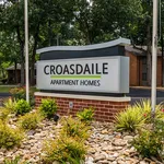 Welcoming front sign of Croasdaile Apartment Homes surrounded by lush greenery and vibrant landscaping, promising a serene living environment.