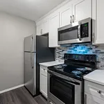Modern kitchen with sleek stainless steel appliances, elegant white cabinetry, and stylish tile backsplash.