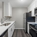 Modern kitchen with sleek stainless steel appliances, elegant white cabinetry, and stylish tile backsplash.