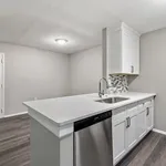 Modern kitchen with sleek white cabinetry and stainless steel appliances, featuring contemporary backsplash and polished quartz countertops.