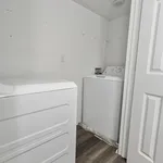 Bright and efficient laundry room featuring modern washer and dryer with sleek design and ample space.