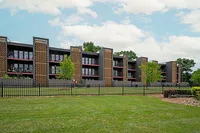 Modern apartment complex with stylish architecture, spacious balconies, and lush green surroundings.