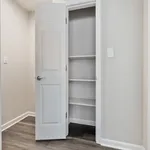 Bright modern closet with open door showcasing ample shelving, perfect for organized storage.