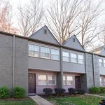 Charming two-story apartment exterior featuring modern architecture with large windows and a landscaped front yard.
