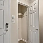Inviting entryway with a sleek closet featuring a modern door and smart lock, perfect for contemporary living.