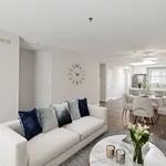 Elegant open-concept living space featuring a modern kitchen, sleek dining area, and cozy living room with stylish decor.
