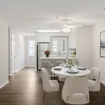 Inviting open-concept dining area with elegant table setting, adjacent to a modern kitchen featuring sleek appliances and stylish decor.
