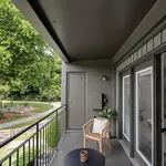 Charming balcony overlooking a lush garden, featuring cozy seating and a modern design for ultimate relaxation.