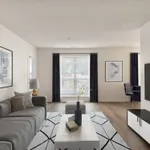 Modern living space with sleek gray sofa, tasteful decor, and bright sunlight filtering through large windows, creating an inviting and stylish atmosphere.