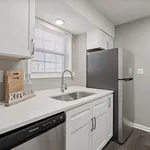 Chic and modern kitchen with sleek stainless steel appliances, elegant white cabinetry, and pristine countertops.