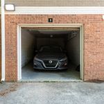 Well-maintained brick garage with a modern car, offering secure parking and added convenience.