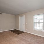 Bright and inviting room featuring neutral walls, large window for natural light, and plush carpeting perfect for a cozy living space.