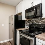 Modern kitchen with sleek stainless steel appliances, stylish tile backsplash, and elegant white cabinetry.