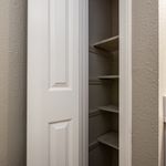 Chic interior closet with ample shelving, perfect for organized storage solutions in a modern home.
