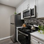 Contemporary kitchen with sleek stainless steel appliances, elegant white cabinetry, and stylish backsplash design, creating a modern and inviting cooking space.