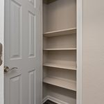 Neatly designed closet with open shelving for optimal storage in a modern apartment.