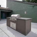 Modern outdoor grilling station featuring a sleek stainless steel barbecue set against a stylish green siding backdrop.