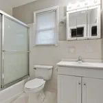 Bright and inviting bathroom featuring a modern vanity, glass-enclosed shower, and elegant lighting for a serene atmosphere.