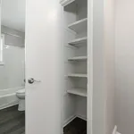 Chic bathroom with modern white shelving, offering ample storage space and contemporary design.