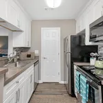 Elegant modern kitchen with stainless steel appliances, chic white cabinetry, and stylish backsplash, perfect for culinary creativity.