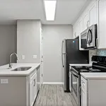 Modern kitchen with stainless steel appliances, sleek white cabinetry, and stylish tile backsplash.
