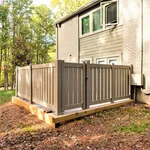 Charming fenced patio area enhancing the outdoor appeal of a cozy apartment, surrounded by lush greenery.