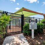 Inviting pet-friendly Bark Park with shaded area, ideal for outdoor fun and relaxation for dogs.