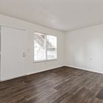 Bright and inviting room with elegant hardwood flooring and large windows offering natural light.