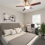 Contemporary bedroom design featuring a stylish ceiling fan, cozy bed with plush pillows, chic artwork, desk with modern chair, and vibrant indoor plant.
