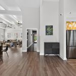Modern interiors featuring an open-concept living space with elegant wood flooring, contemporary furniture, and sleek stainless steel appliances.