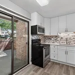 Modern kitchen with sleek cabinetry, stainless steel appliances, and cozy outdoor patio access.