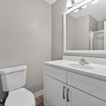 Elegant bathroom with modern fixtures, a sleek vanity, and ample natural light creating a serene atmosphere.