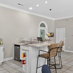 Elegant apartment kitchen featuring a stylish breakfast bar with comfortable seating and ambient lighting.