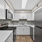 Modern kitchen with sleek stainless steel appliances, elegant white cabinetry, and a stylish mosaic backsplash, creating a bright and inviting space.