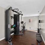Sleek modern gym with state-of-the-art fitness equipment and open space for exercise.