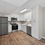 Modern kitchen with sleek stainless steel appliances, elegant white cabinetry, and stylish tile backsplash.