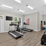 Contemporary fitness room with sleek treadmills and vibrant exercise equipment, ideal for a home workout.