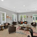 Charming communal lounge with stylish seating, modern decor, and abundant natural light, creating a welcoming atmosphere.