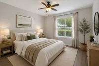 Elegant bedroom with soft natural lighting, featuring a cozy bed, stylish decor, and a large window overlooking green scenery.