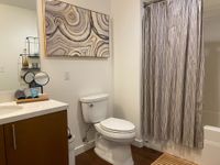 Sink into Serenity Elegant bathroom featuring modern decor with abstract wall art, sleek vanity, and sophisticated shower curtain.