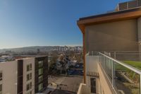 Vibrant Surroundings, Endless Possibilities Urban apartment view showcasing a scenic city skyline, modern buildings, and charming neighborhood on a sunny day.