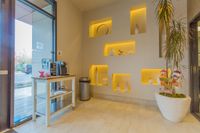 A Lobby That Sets the Tone Inviting lobby interior with modern decorative shelves, warm lighting, and a convenient coffee station.